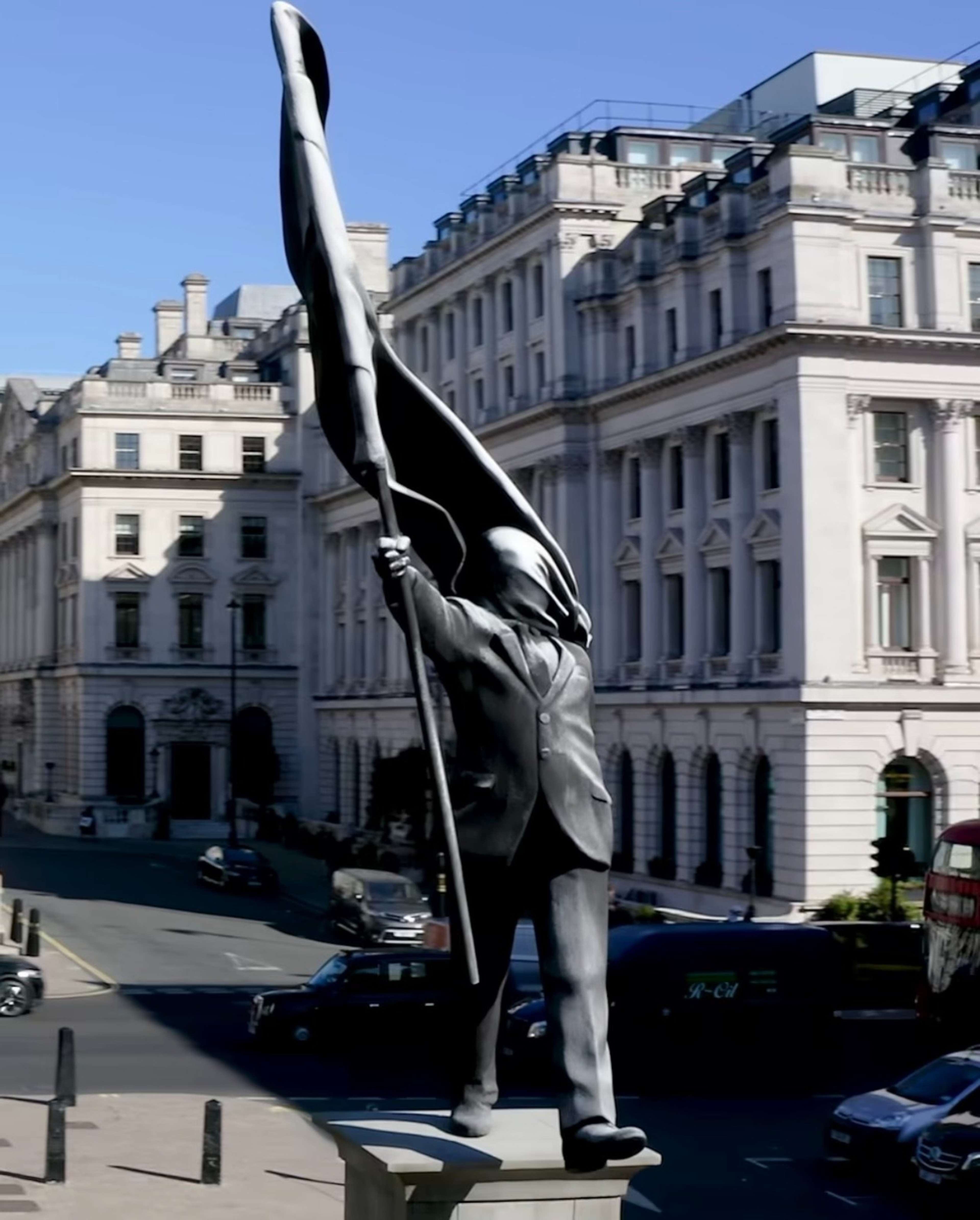 Banksy's New Sculpture in London: A Suited Figure, a Flag, and a Fall