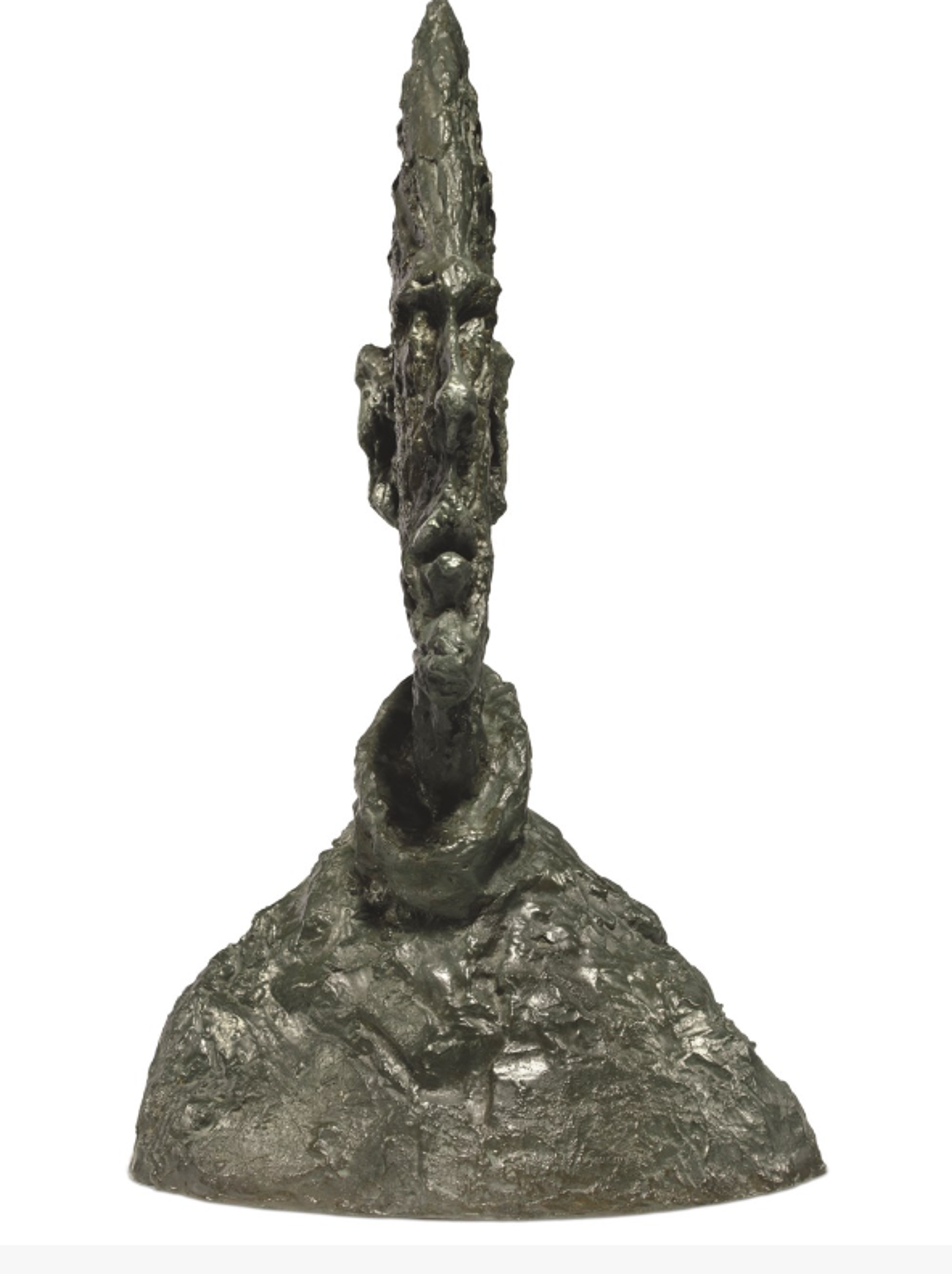 Bronze sculpture resembling a tall, pointed head rising from wide shoulders. From the front, the head is impossibly thin, but from the side, the profile is more realistic. The rough, textured surface creates an organic quality.