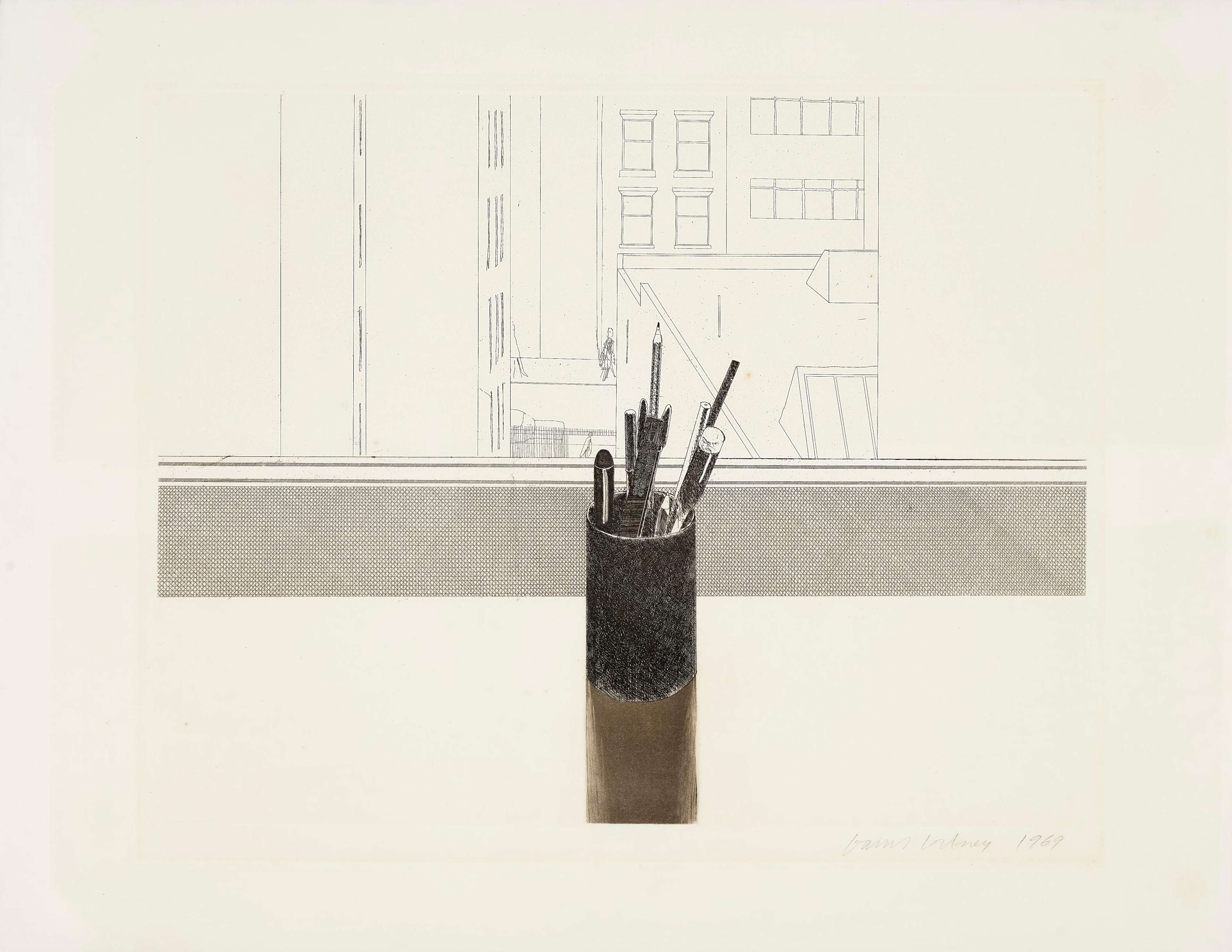 A pot of pens against a back drop of buildings 