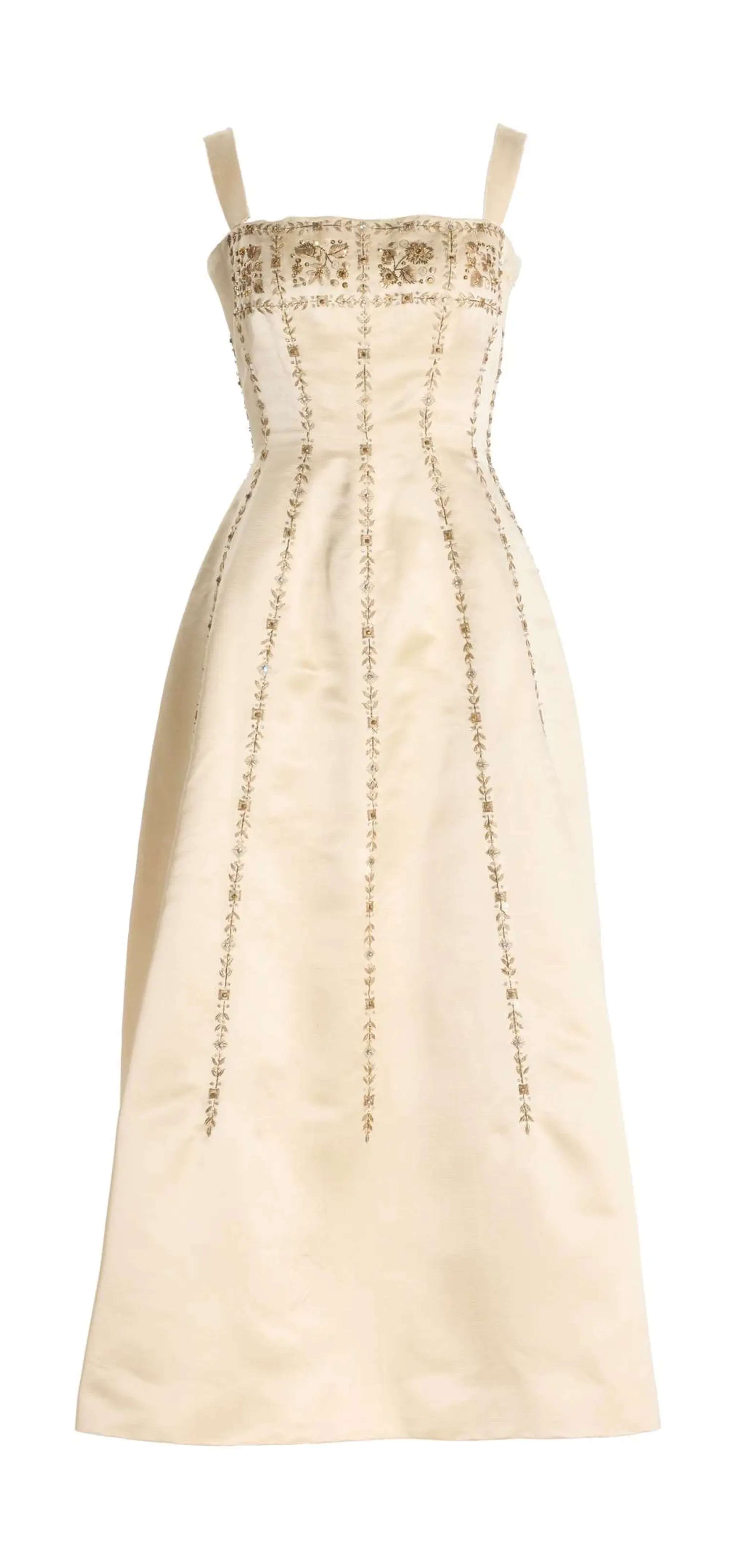 Marilyn Monroe’s pale peach evening gown with a fitted silhouette, embellished bodice, and flowing floor-length skirt.