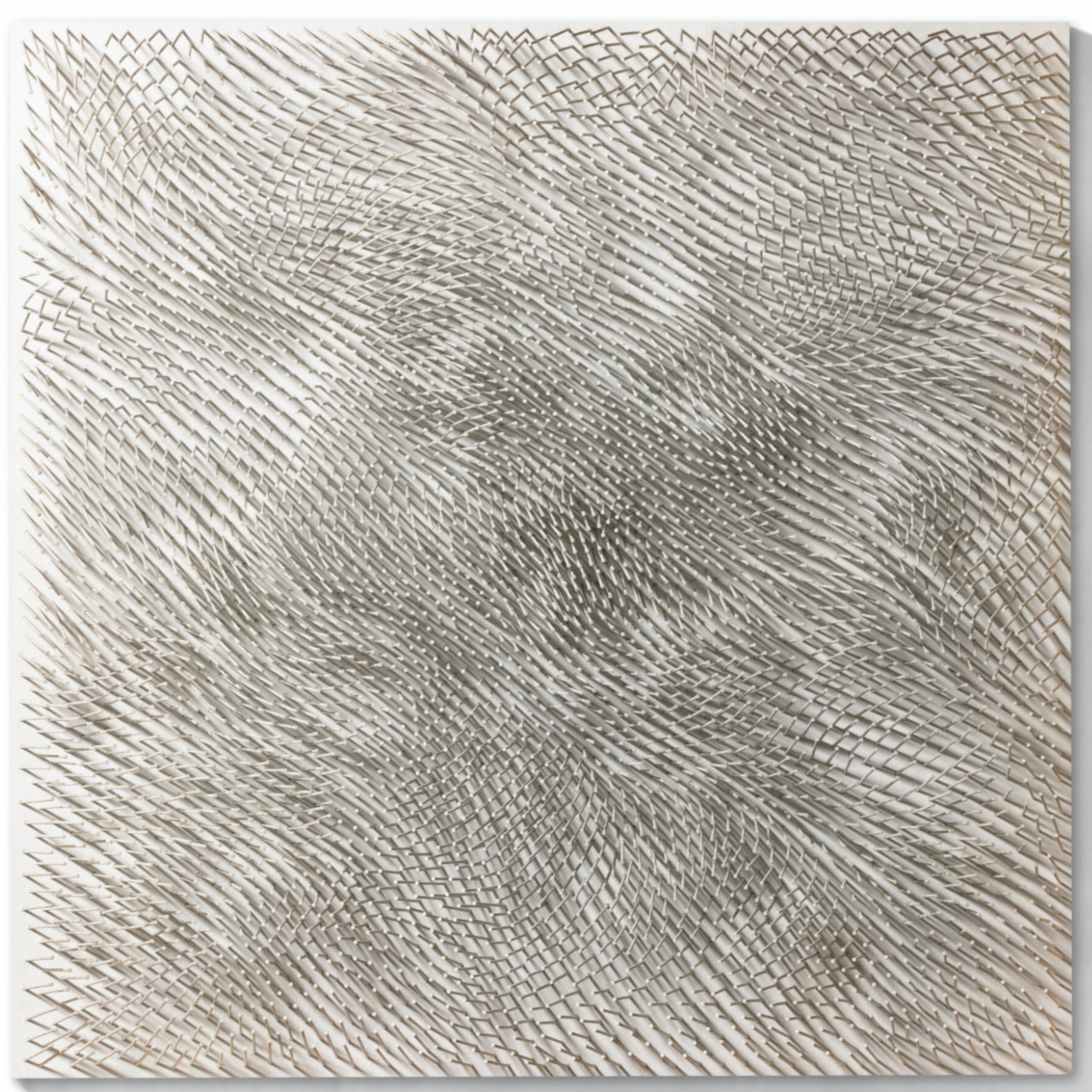 White-painted nails hammered at varying heights and angles cover the entire surface. The resulting textural landscape captures and transforms light, creating clear areas of shadow and light. The nail arrangement suggests gentle waves or ripples frozen in perpetual motion.