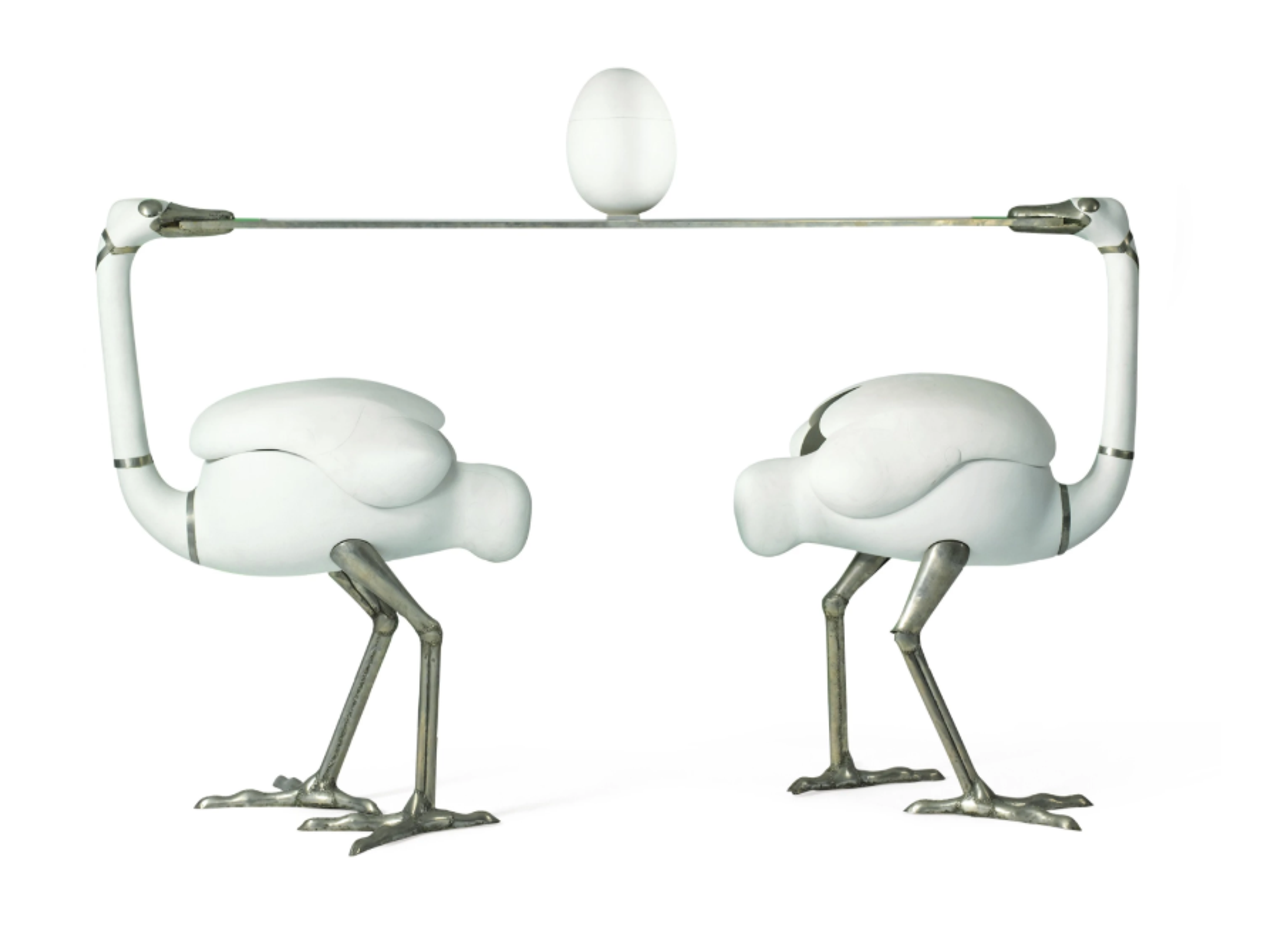 A steel bar comprising two white, stylised ostrich forms with elongated necks leaning back to support the horizontal bar surface. On top of the bar is a white egg. 