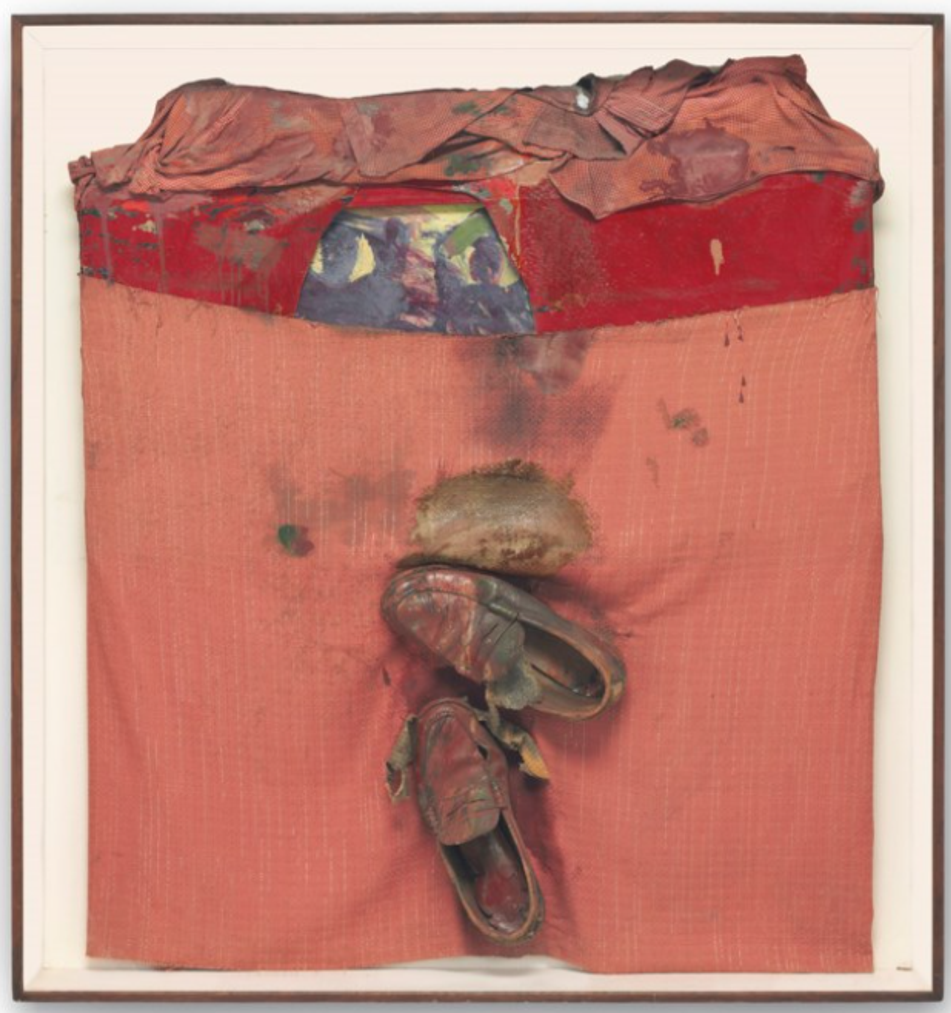 A red square of fabric mounted on a white canvas. The fabric is gathered at the top and has a thick bright red stripe. Towards the bottom, two shoes are attached.