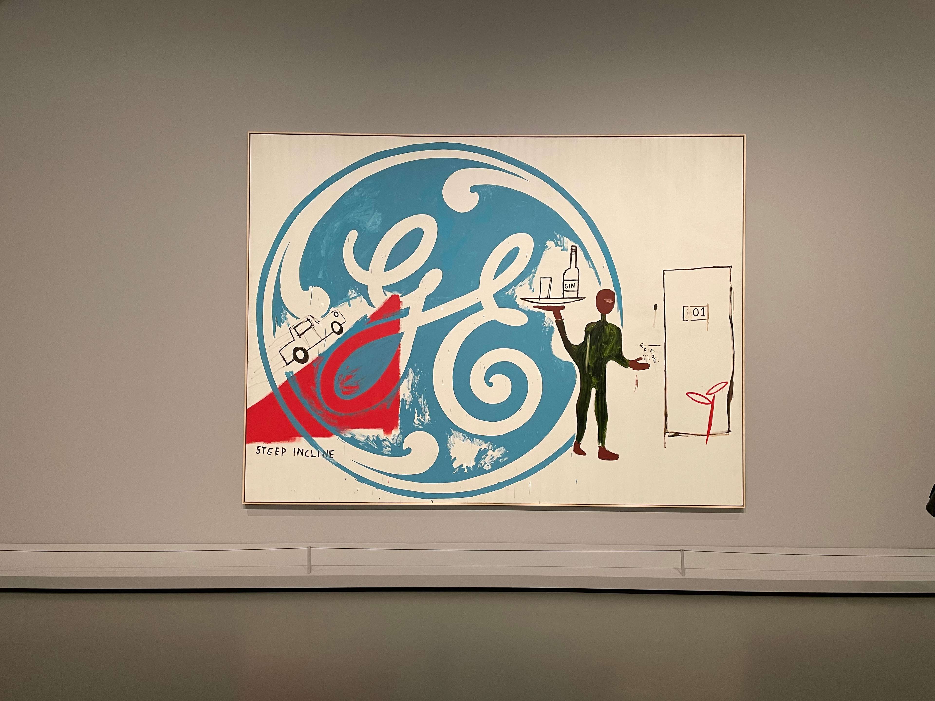 Vue de l'installation de « Painting Four Hands ». Une grande œuvre arborant le logo bleu de General Electric.