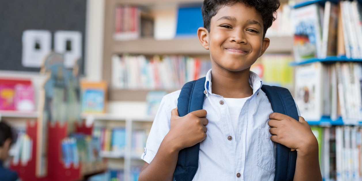Calm and confident child in a school environment, representing emotional balance and reduced anxiety supported through homeopathic care.