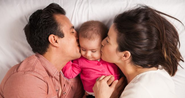 Peaceful infant resting in a parent’s arms, representing gentle and safe homeopathic care for babies.