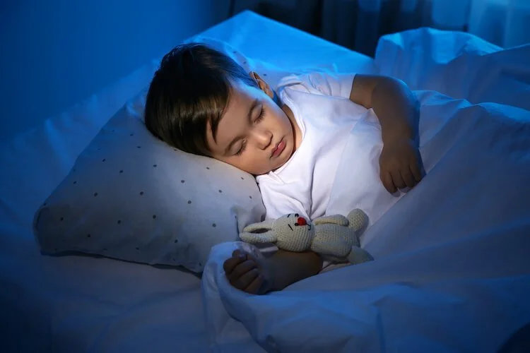 Child sleeping peacefully at night, representing restored sleep and calm supported through homeopathic care.