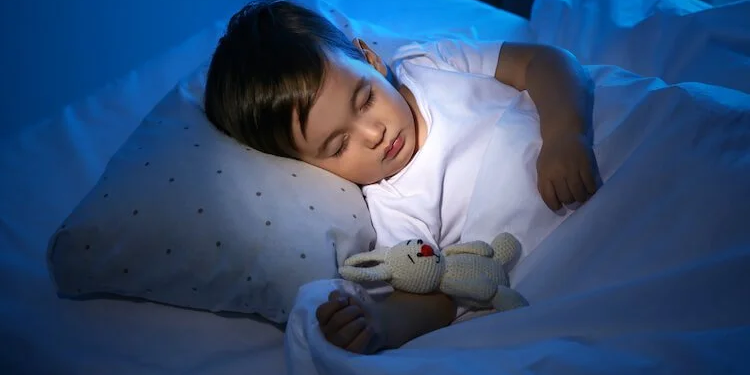 Child sleeping peacefully at night, representing restored sleep and calm supported through homeopathic care.
