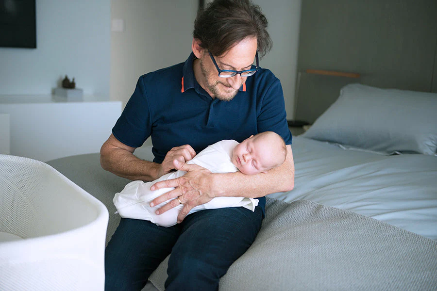 Parent gently comforting a baby with digestive discomfort, representing natural homeopathic support for infant digestion.