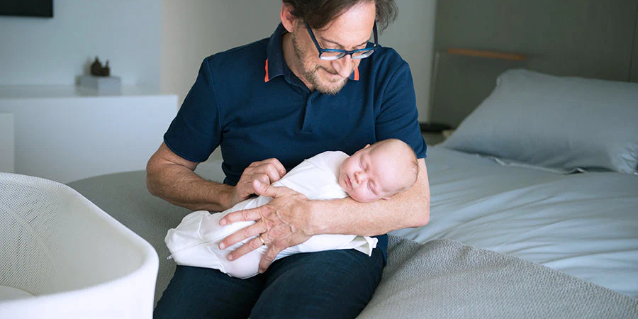 Parent gently comforting a baby with digestive discomfort, representing natural homeopathic support for infant digestion.