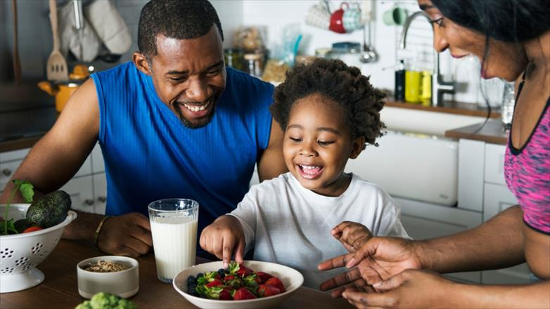 Child enjoying a healthy meal comfortably, representing improved food tolerance and digestive health.