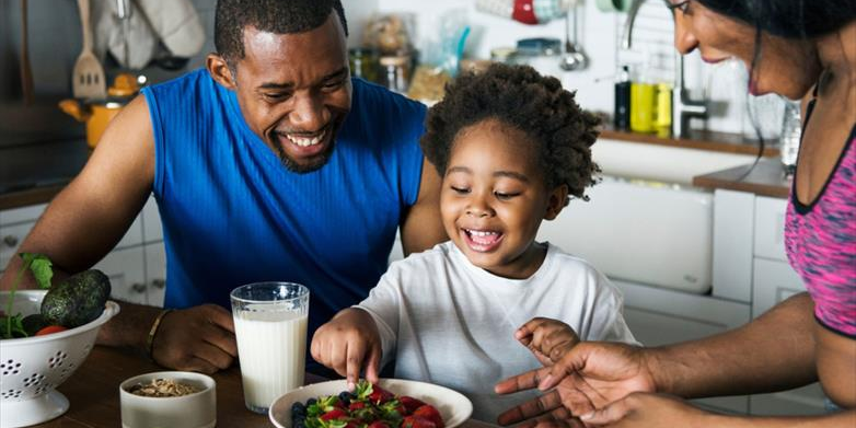 Child enjoying a healthy meal comfortably, representing improved food tolerance and digestive health.