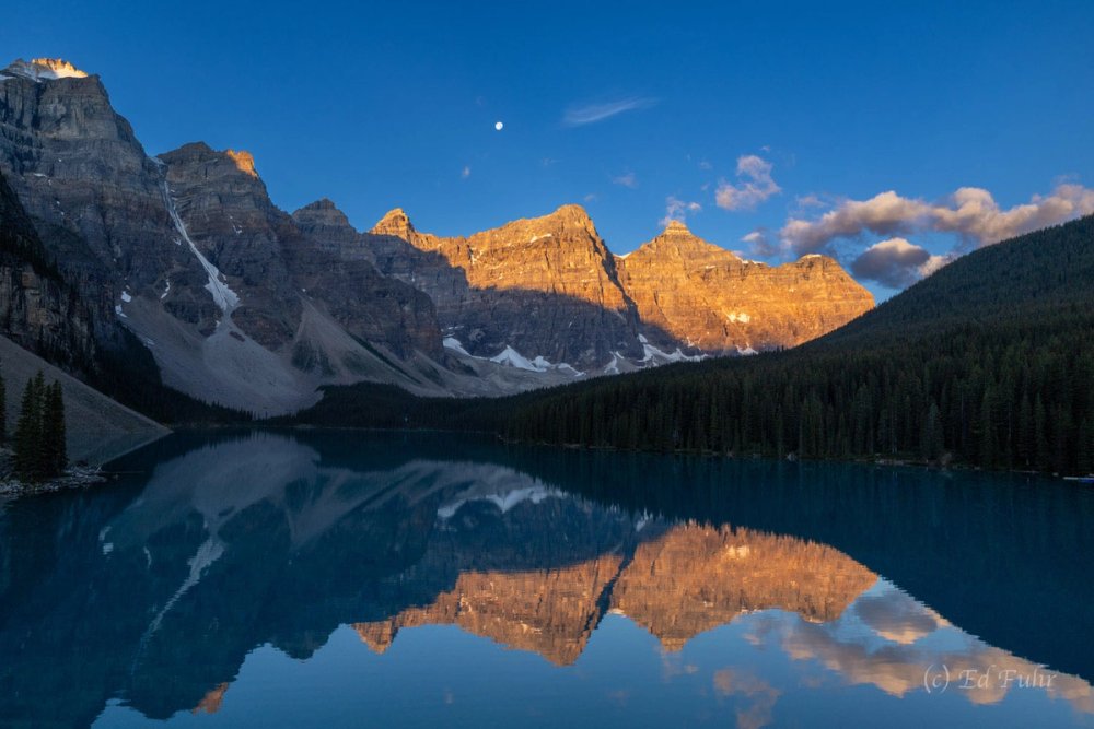Canoes on Moraine Lake at sunrise in Banff National Park