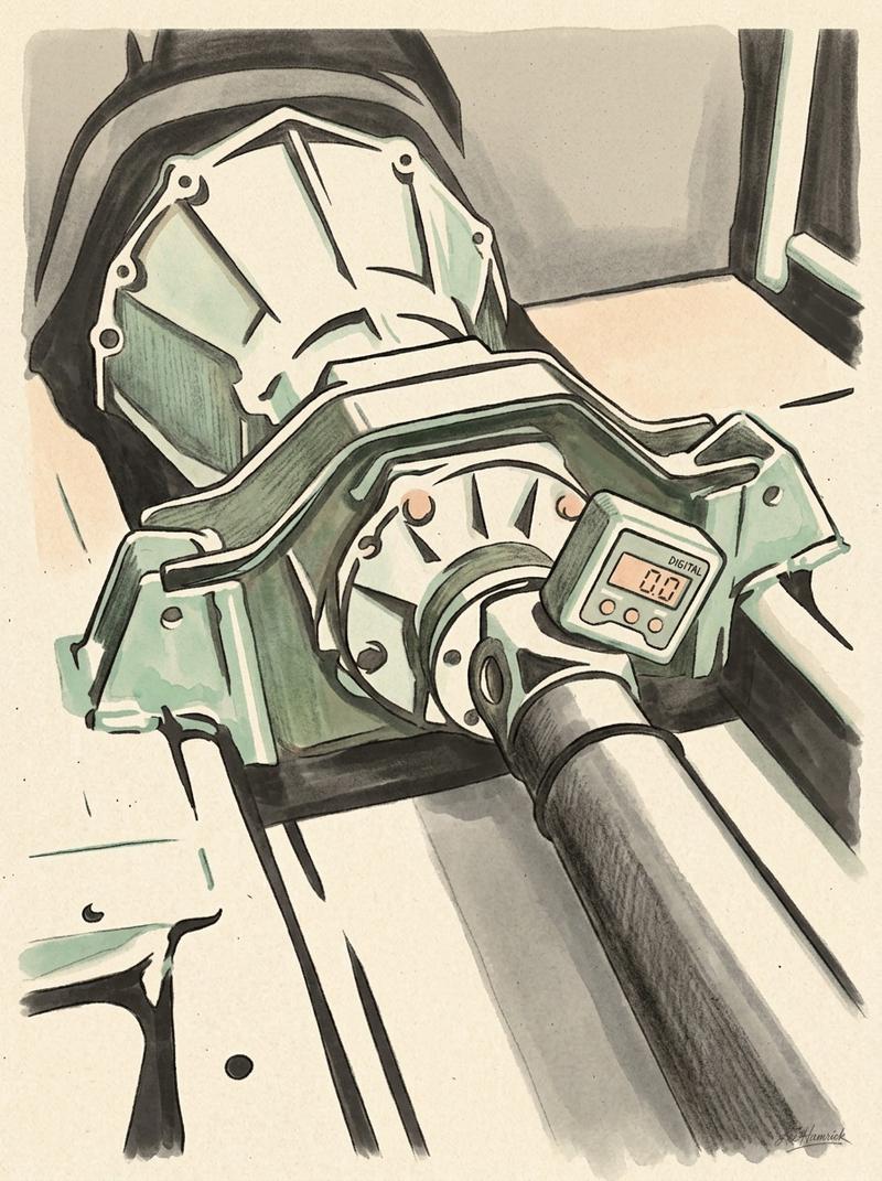 A driveline angle measurement setup on a budget racecar transmission tunnel, with a digital angle gauge resting on the output shaft flange.