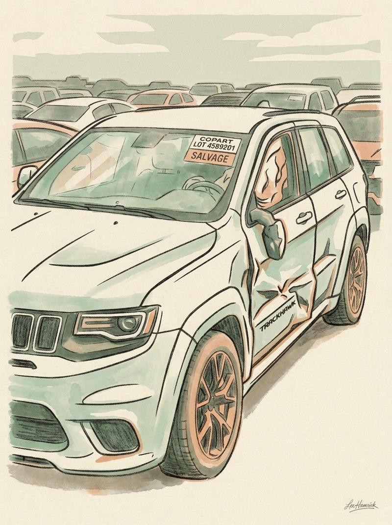 Copart auction lot with a totaled widebody Jeep Grand Cherokee Trackhawk.