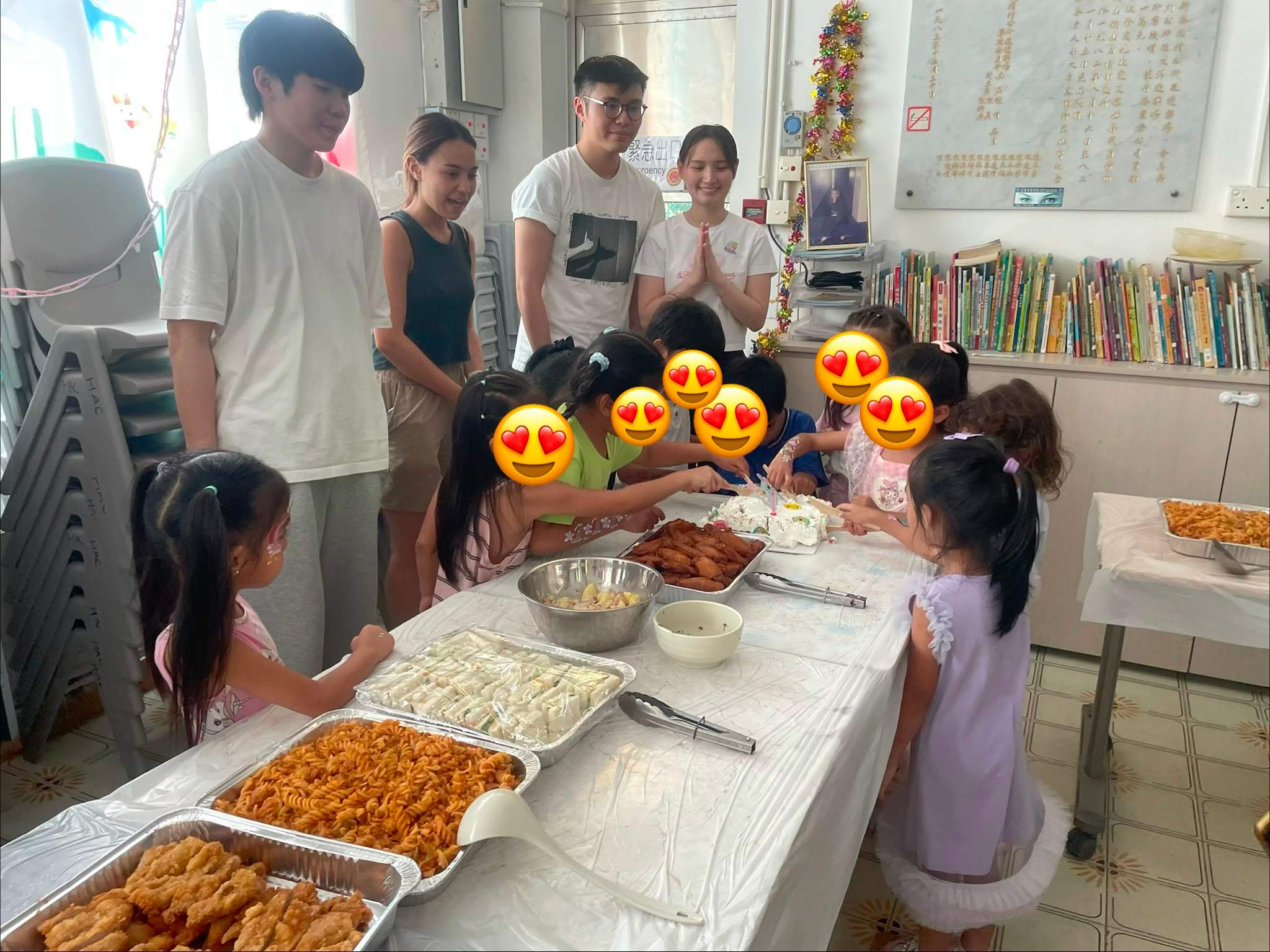 Children approach a table filled with prepared food.