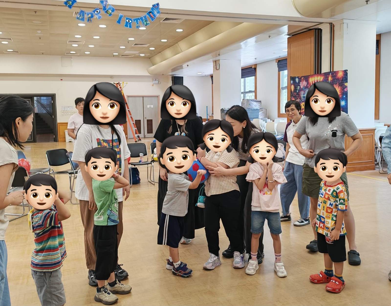 A group gathers around an indoor party activity with colorful props.