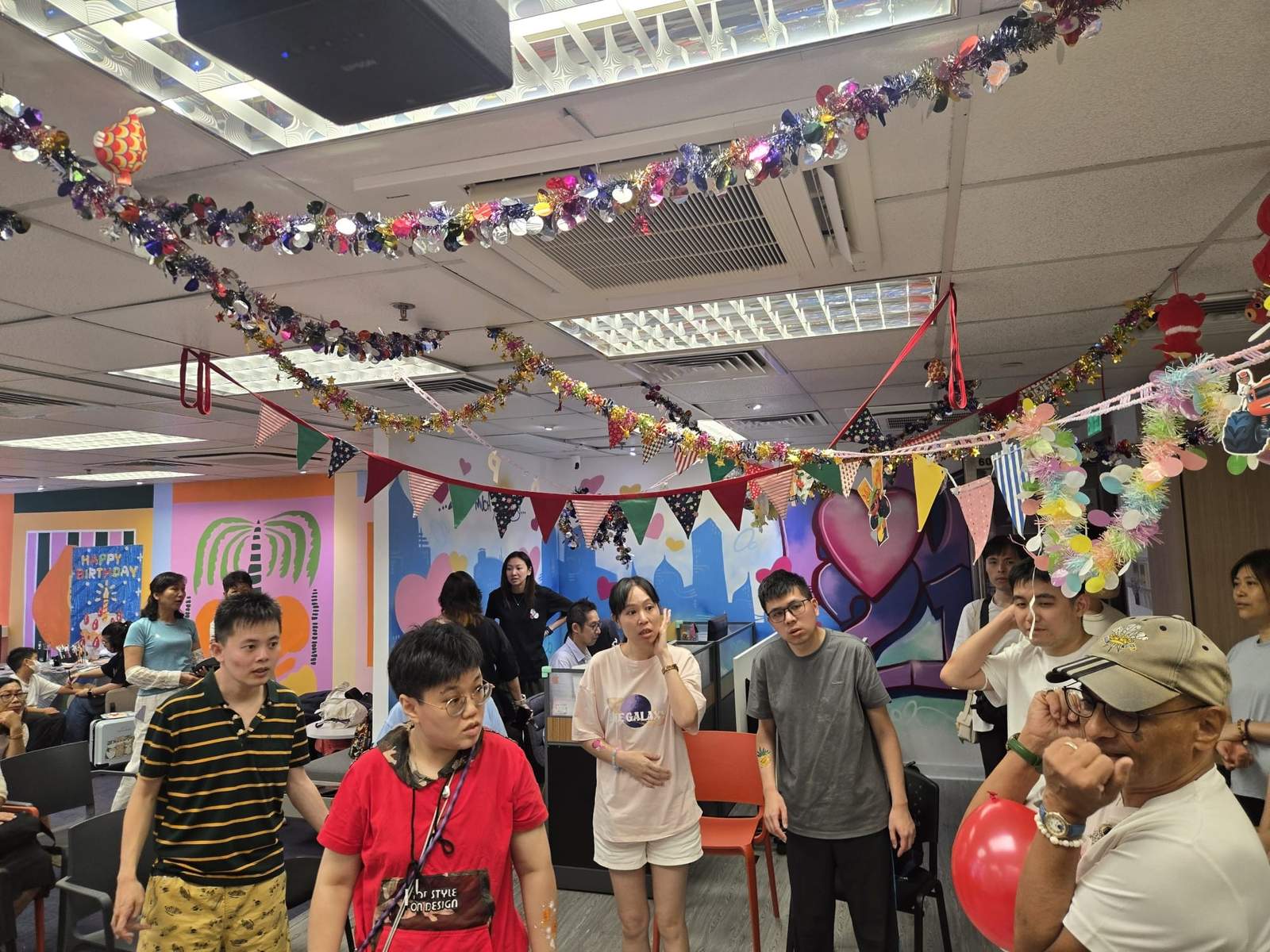 Participants watch a group activity in the decorated party room.