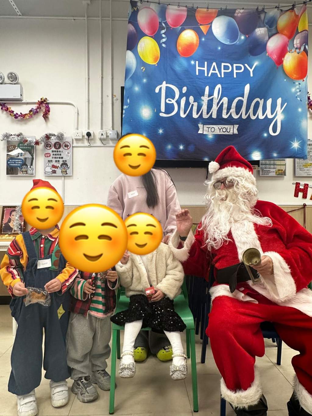 Four children pose beside a seated costumed adult.