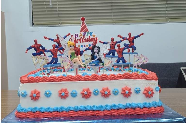 A Spider-Man and fairies sheet cake with a name flag for every celebrant, by Bharti.