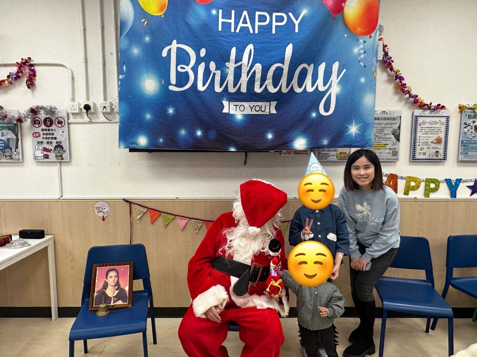An adult and two children pose beside a costumed adult.