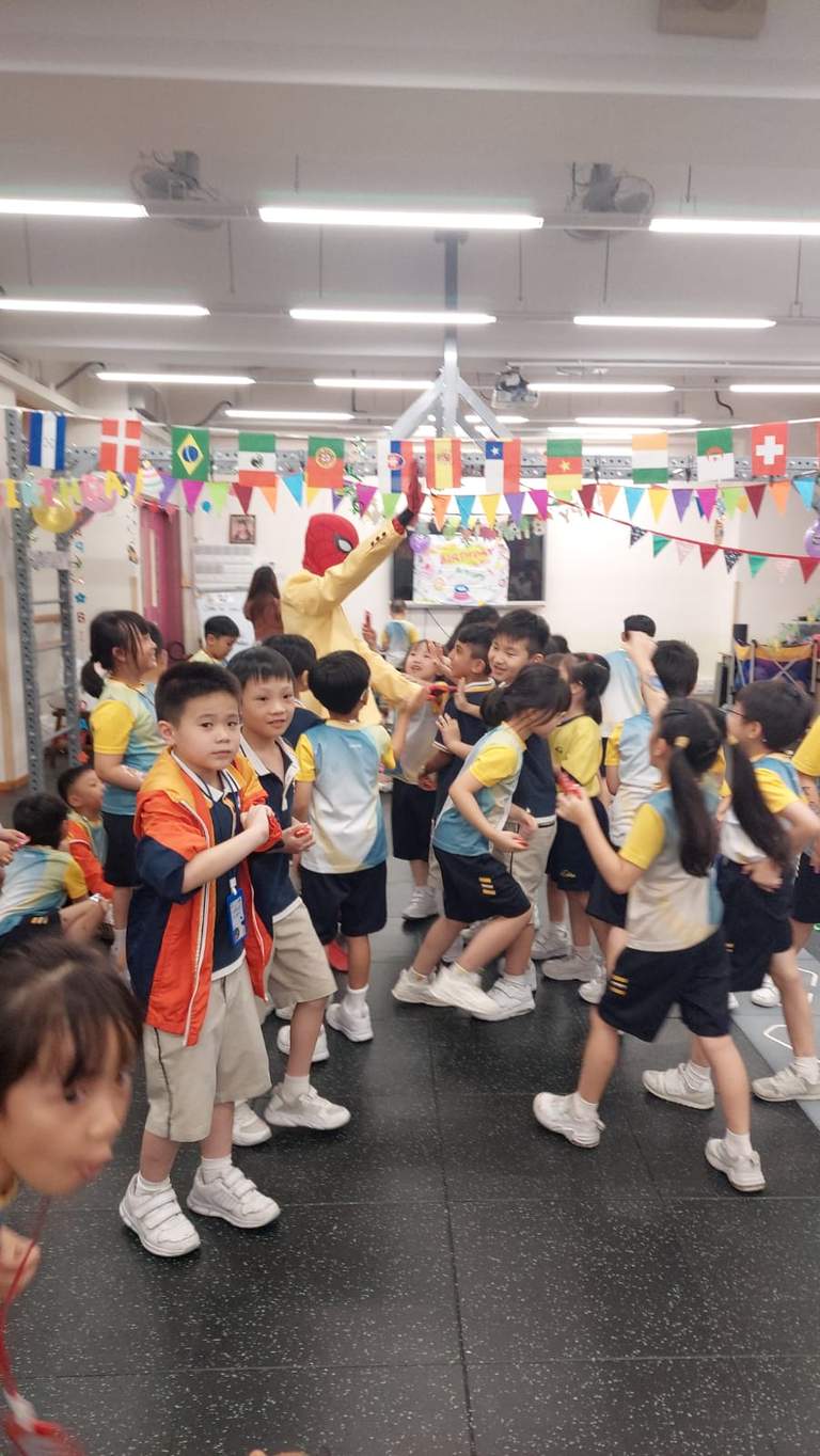 Children form a line during an indoor group activity.