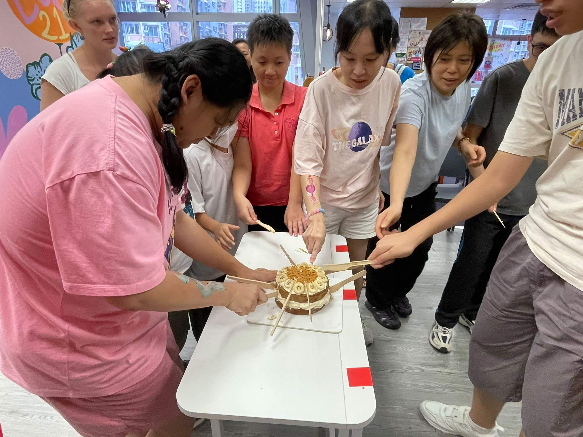 Participants gather around the birthday cake for the celebration.