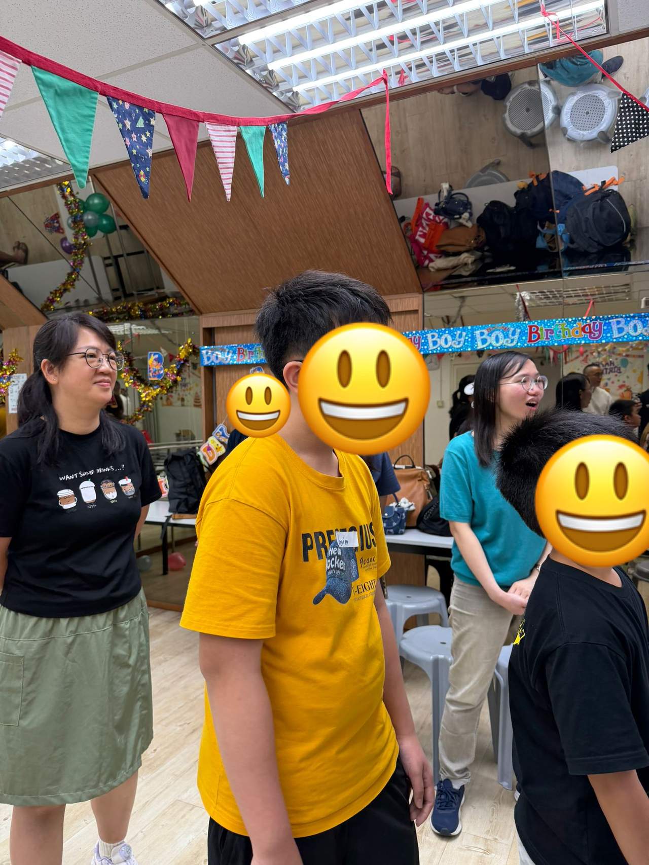 Participants stand together beneath birthday decorations.