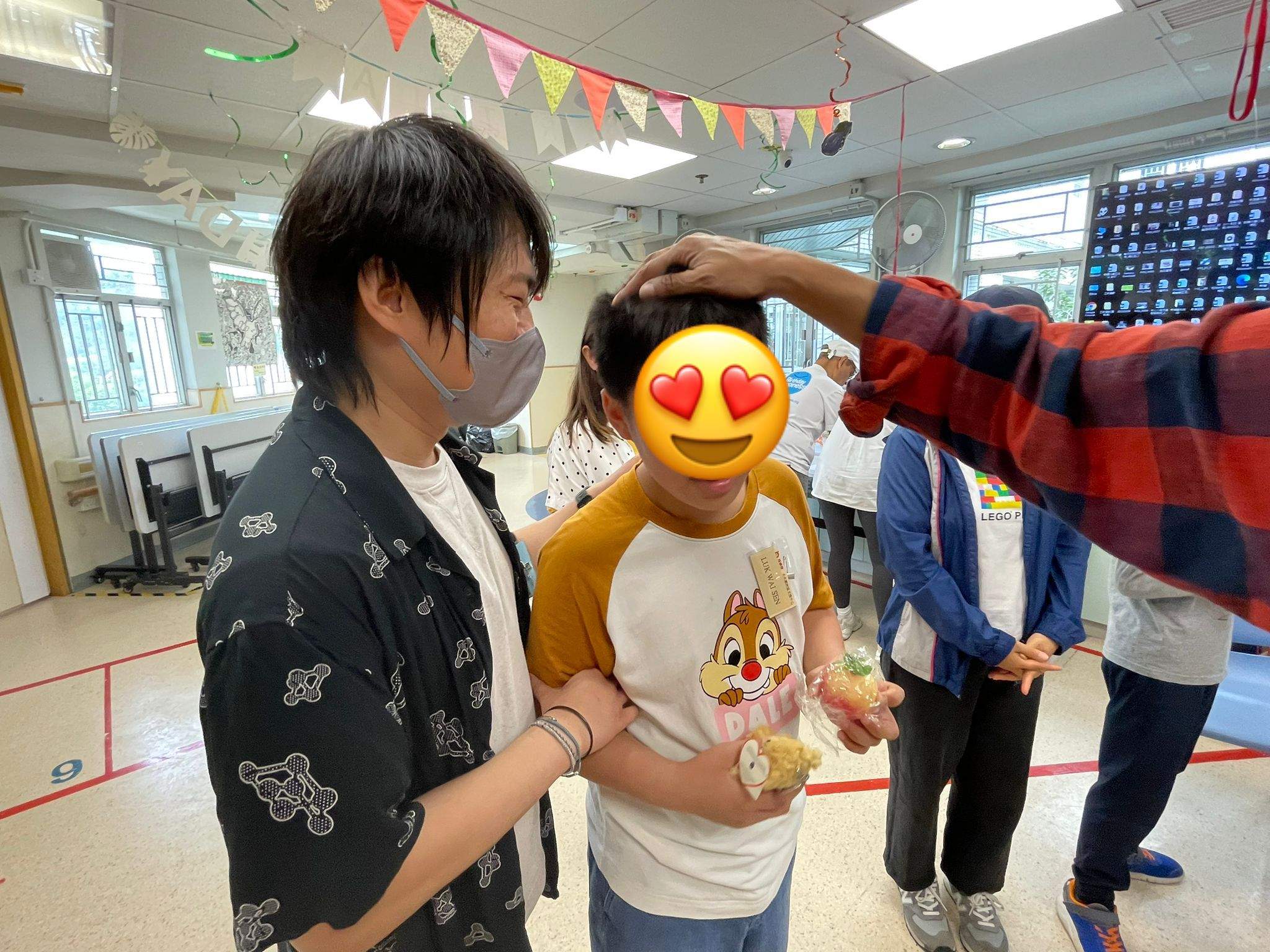An adult reaches towards a participant during a game.