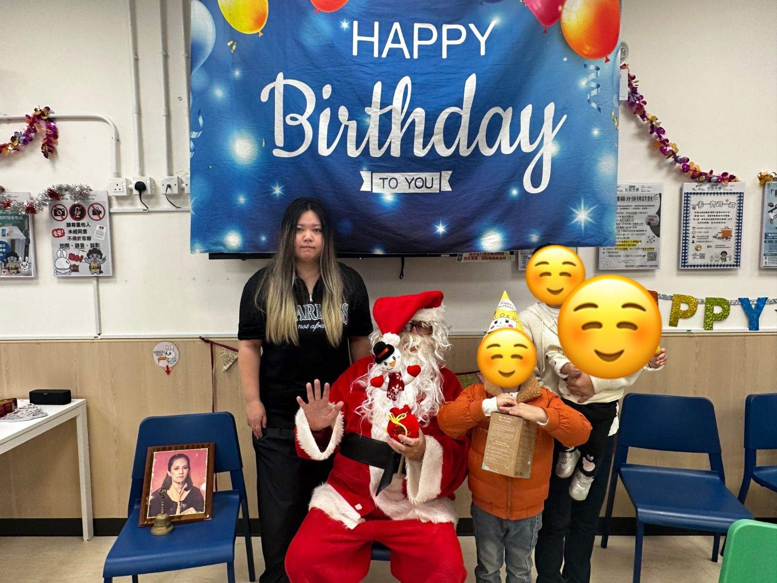 A costumed adult poses with children and an adult.