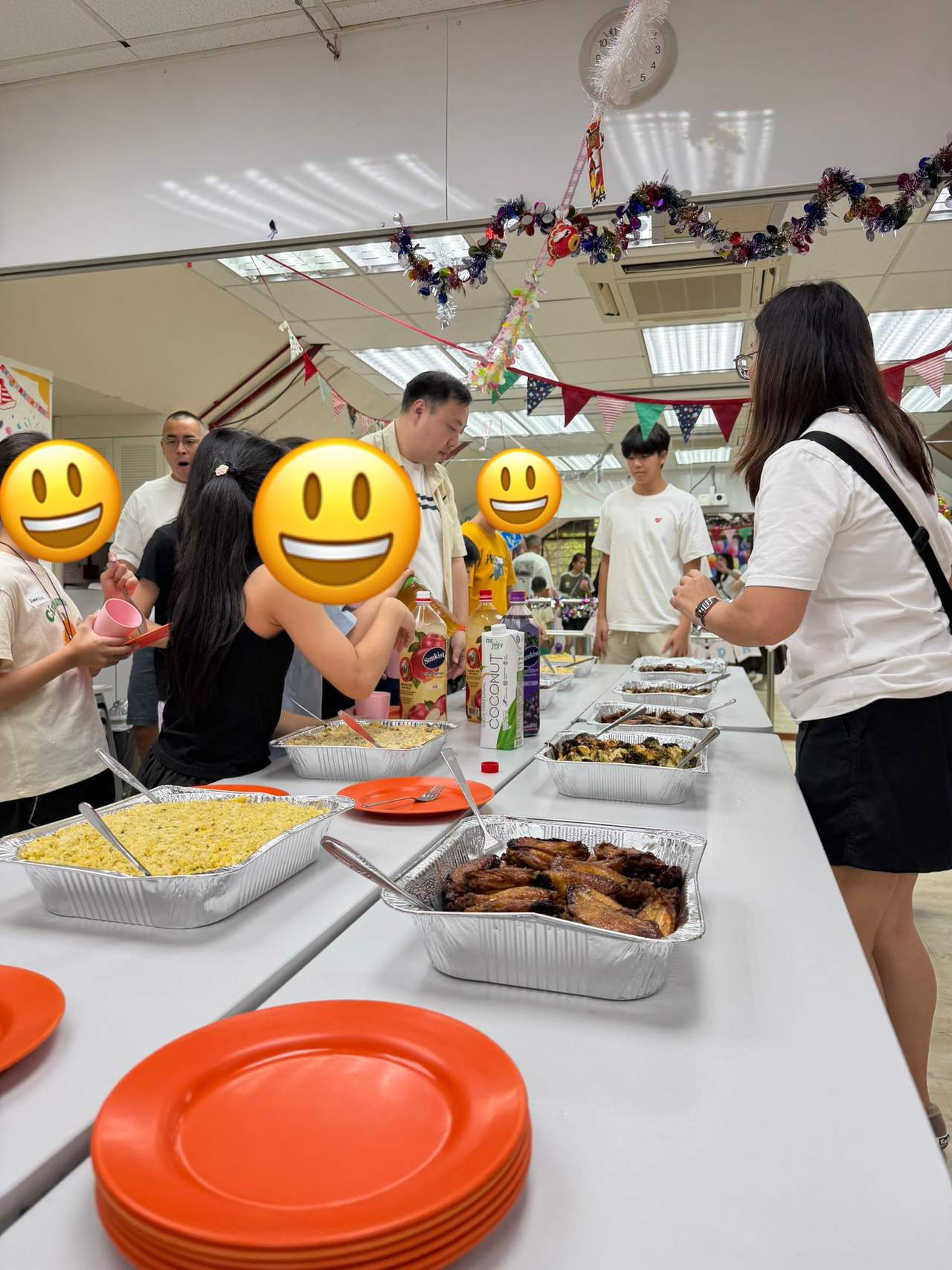 Participants gather around tables of food for a shared meal.