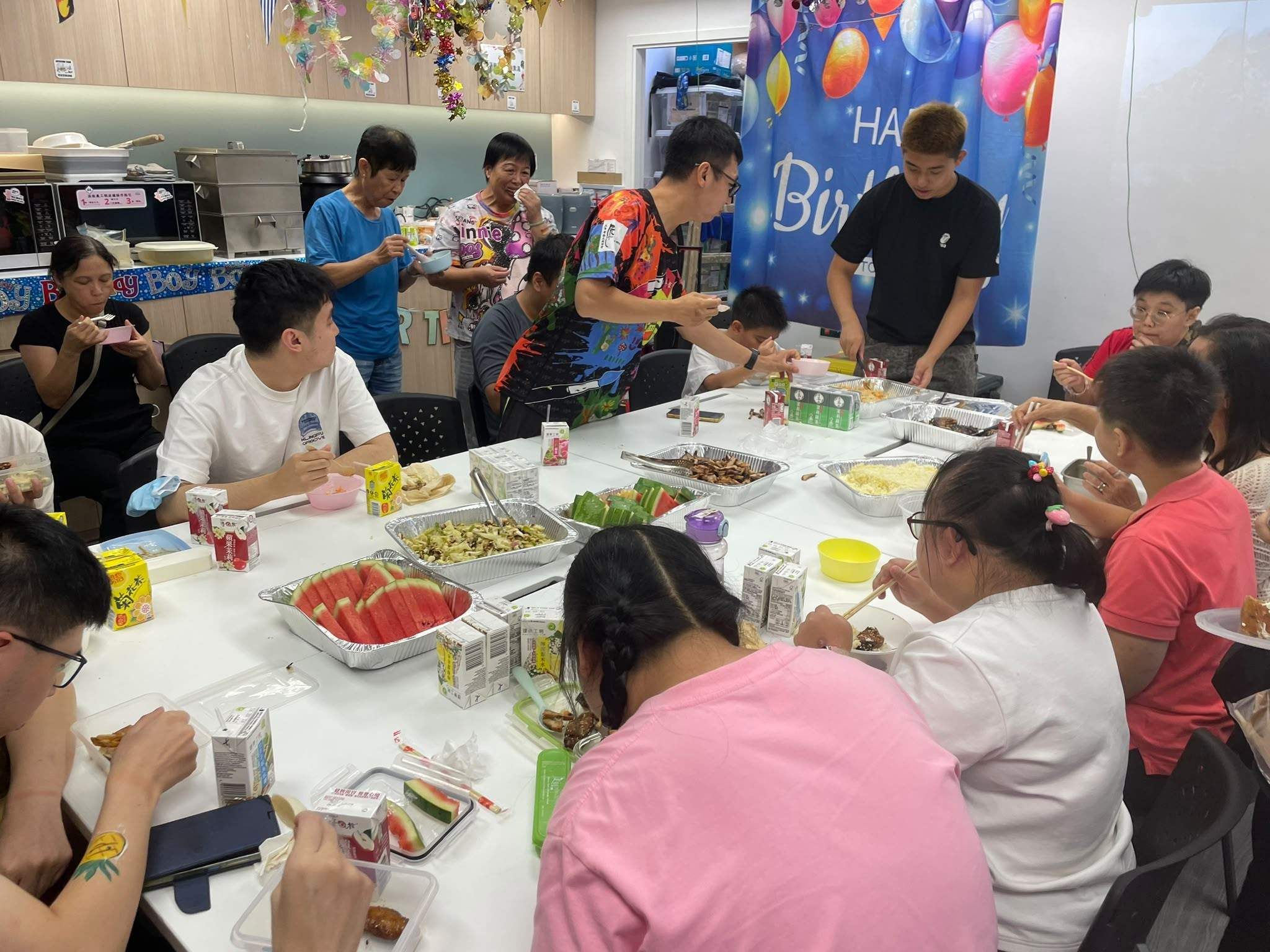 Participants work together around a table of craft materials.