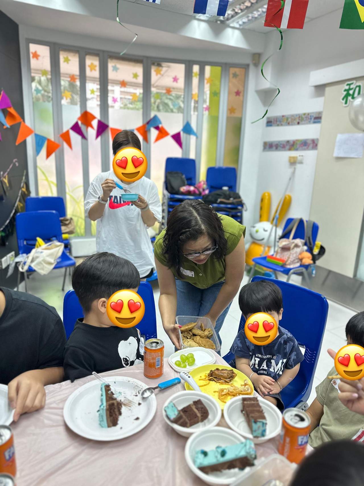 Children eat cake together at a small table.