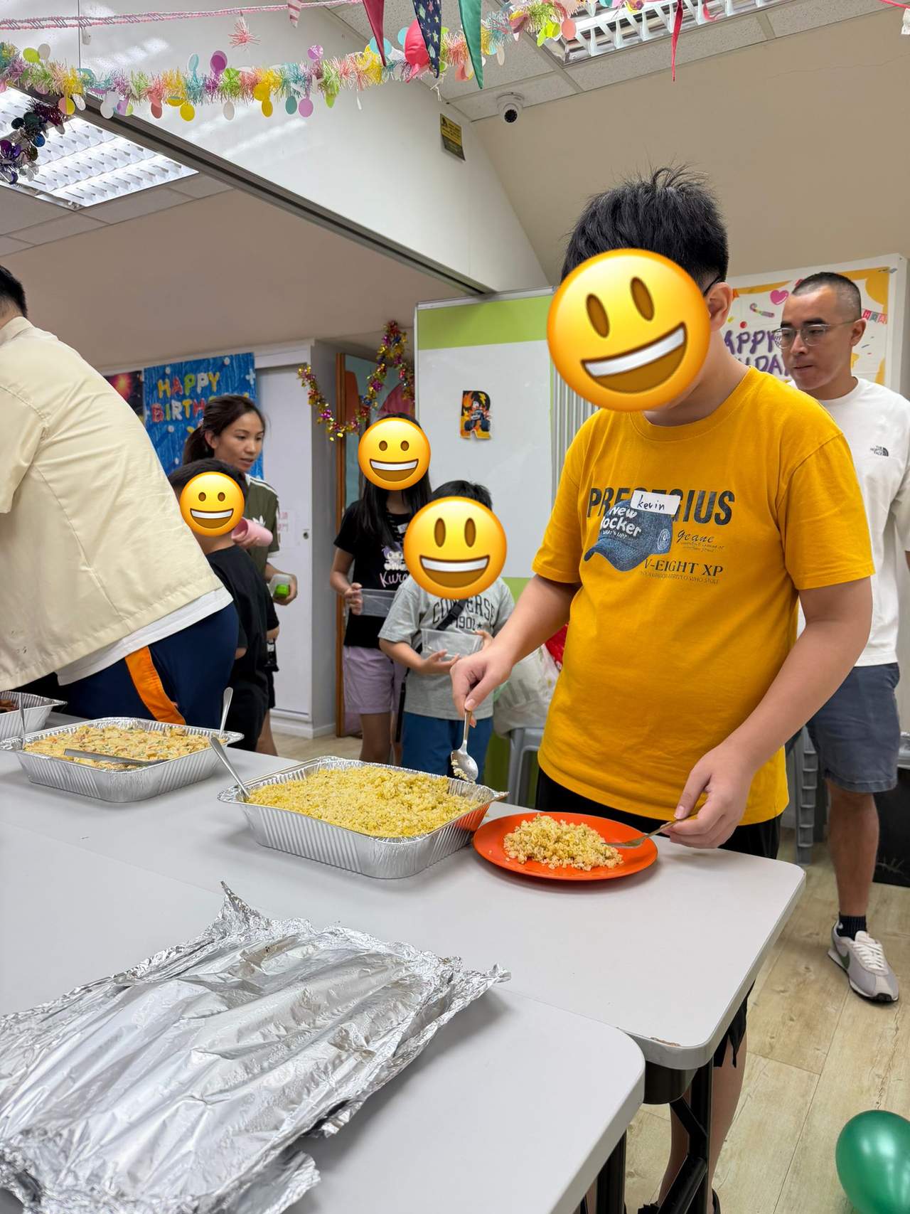 A participant serves food from a tray during the shared meal.
