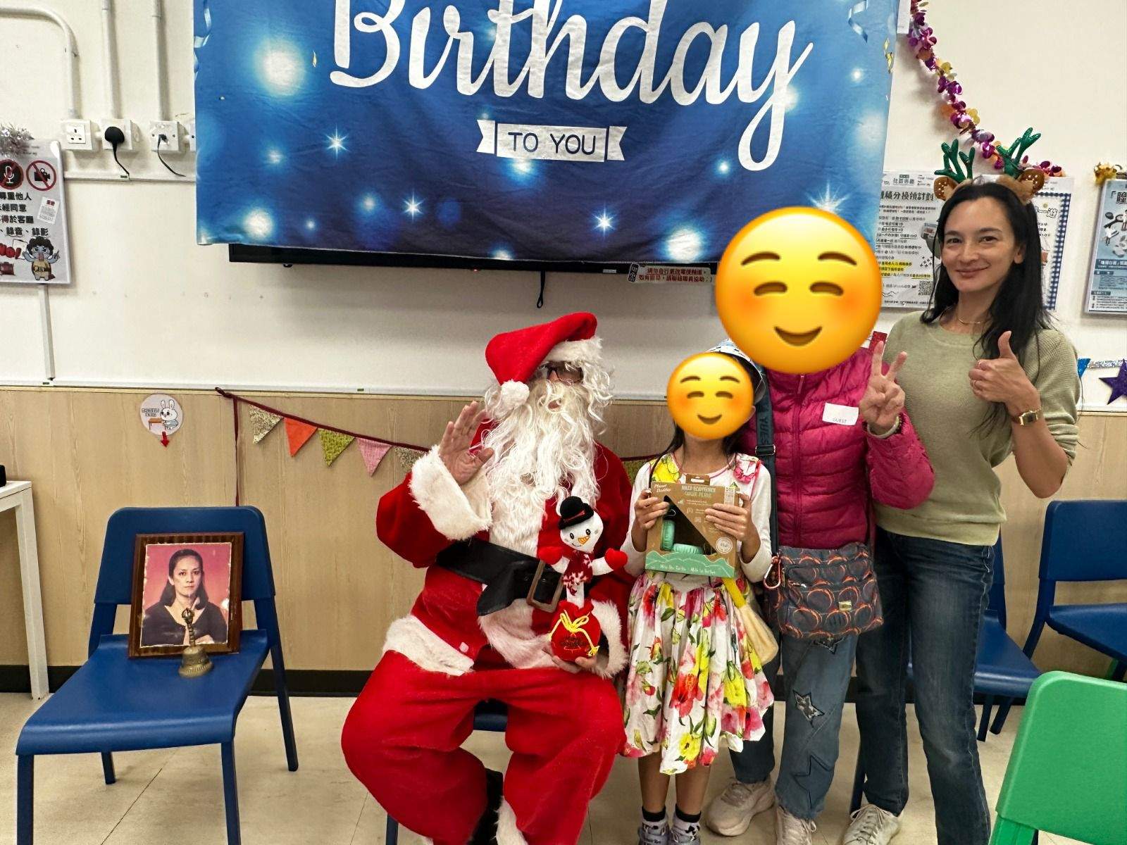 A costumed adult poses with a child and two adults.