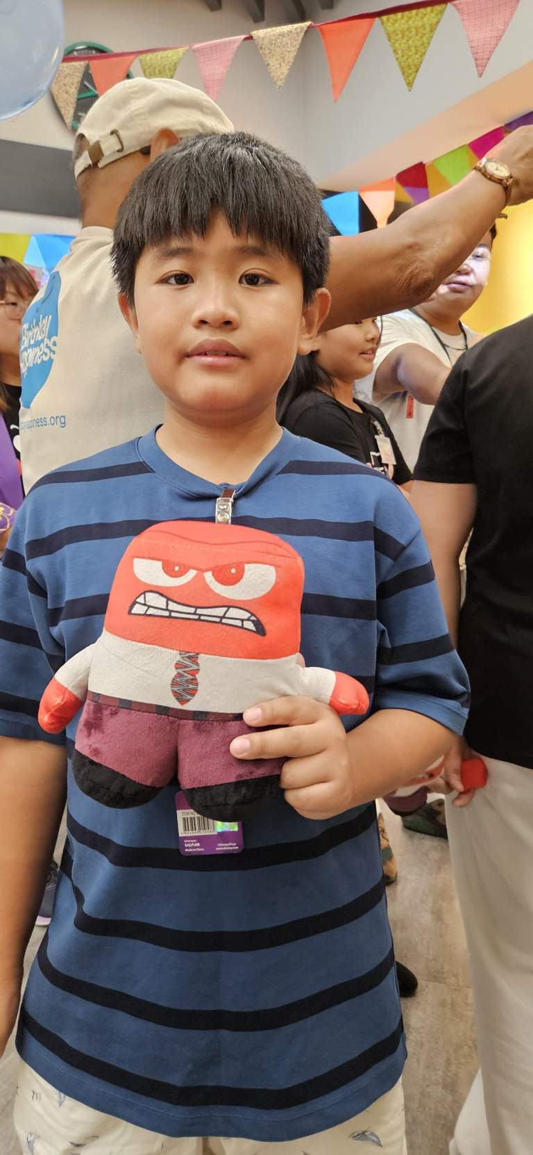 A child holds a small gift bag for the camera.