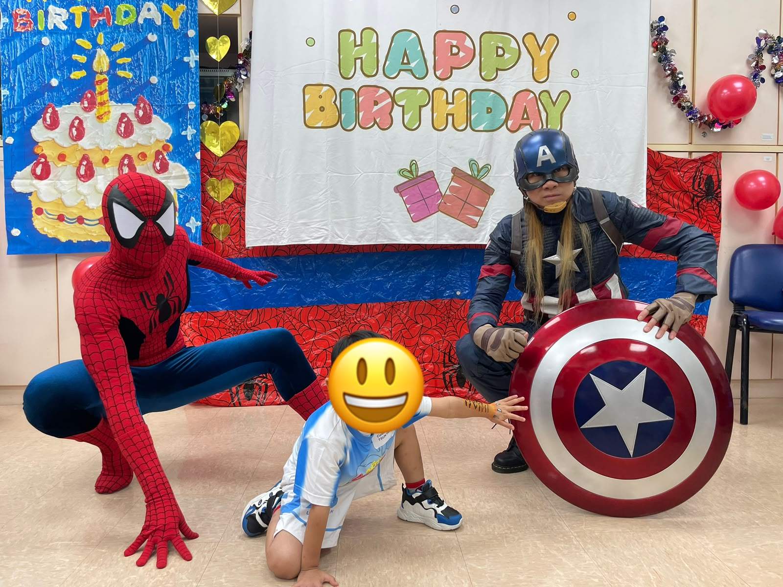Two costumed adults kneel beside a child holding a balloon.