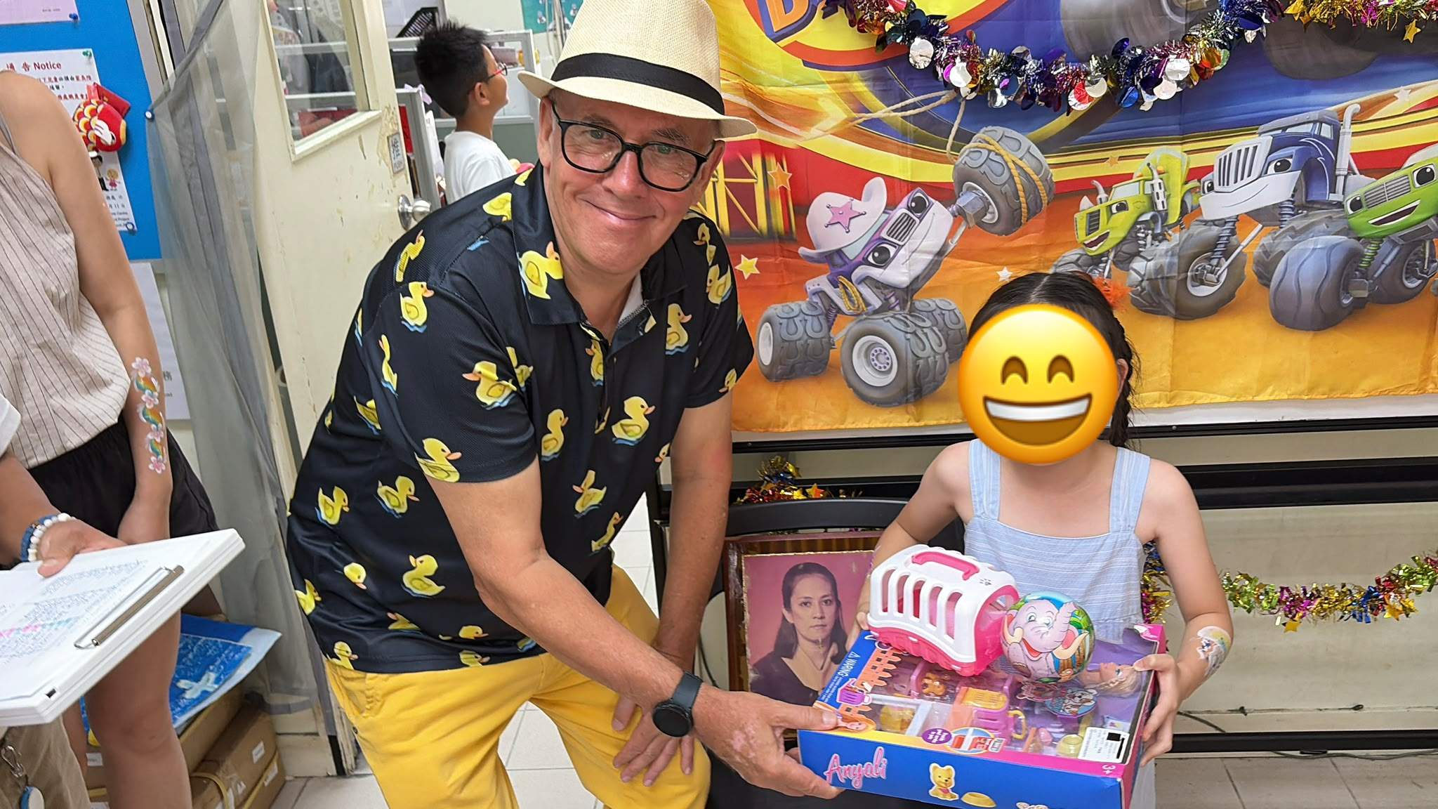 A volunteer presents a toy set to a child.