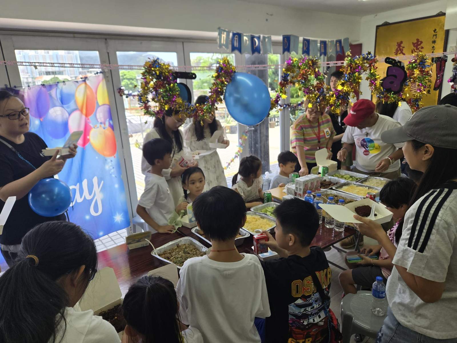 A crowded group gathers around a table during an activity.