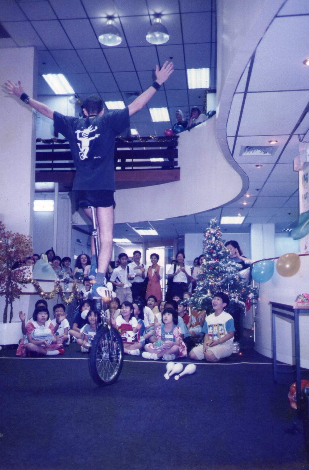 Ben performing on a five-foot unicycle at a children's Christmas party.