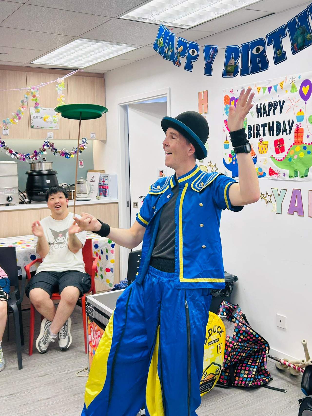 A performer balances a spinning plate on a stick.