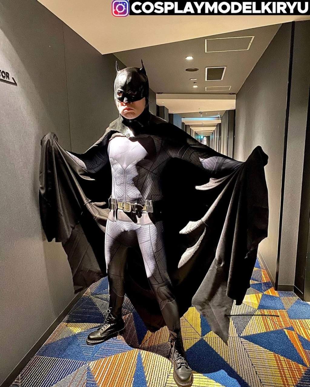 Kiryu Chan as Batman, cape spread wide.