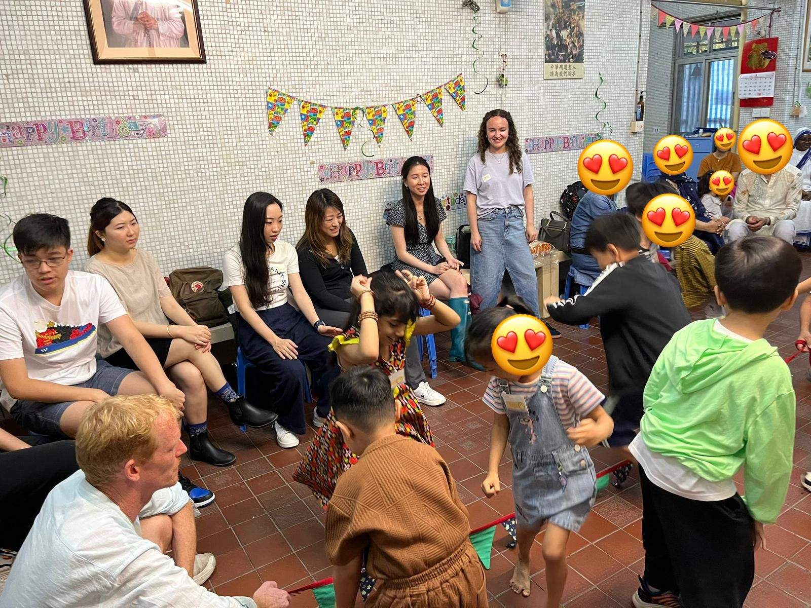 Adults and children gather in a circle during an activity.