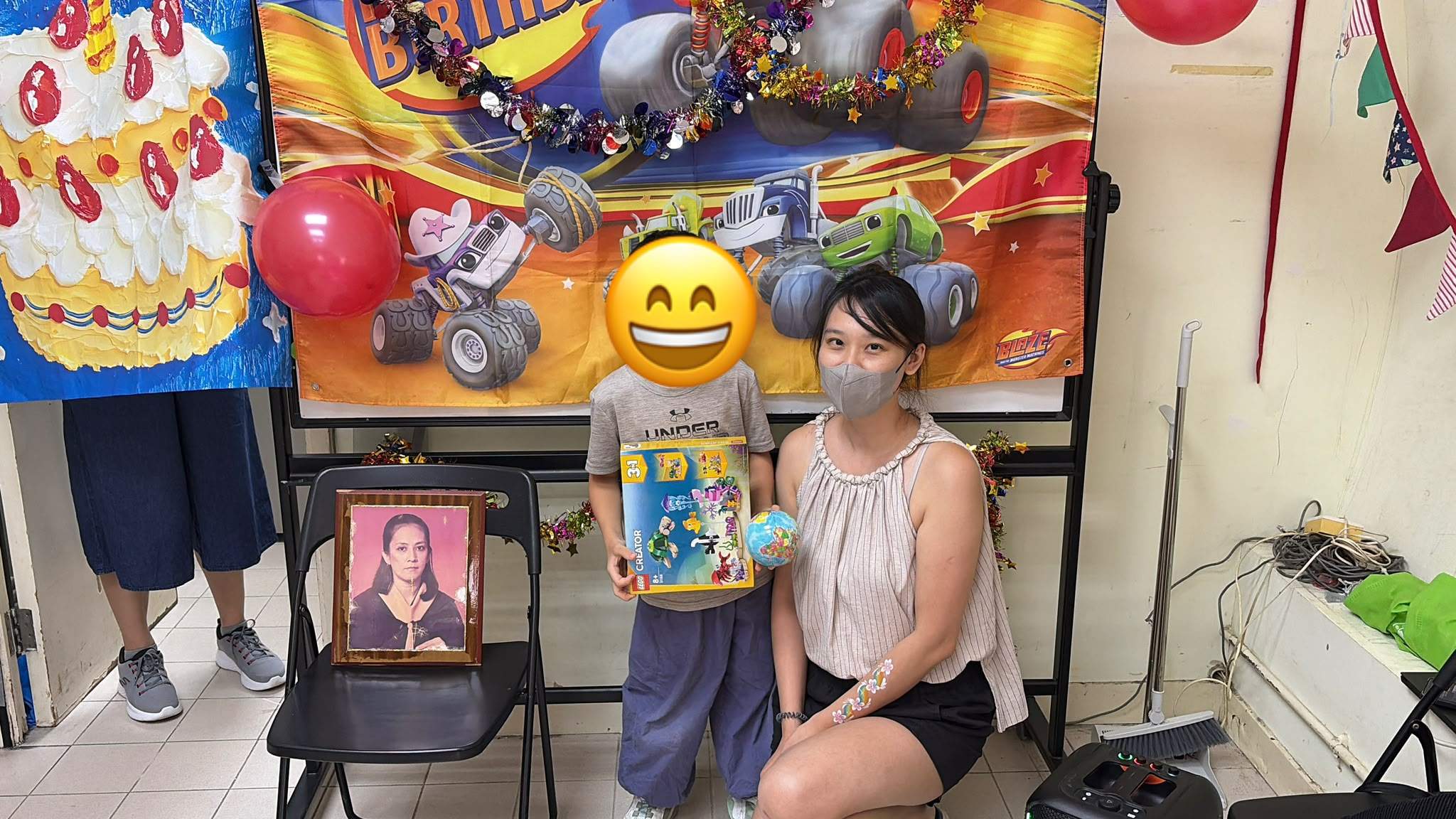 A child holds a boxed gift beside a volunteer.