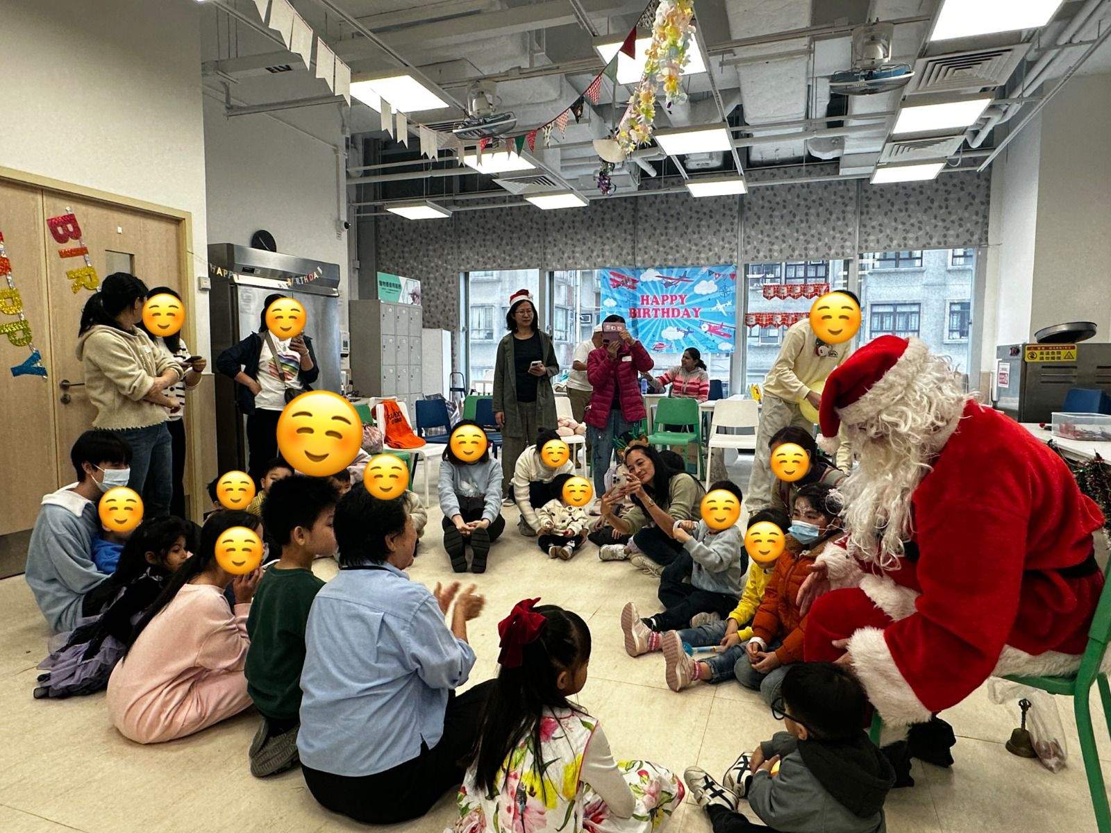 Children sit on the floor facing a costumed adult.