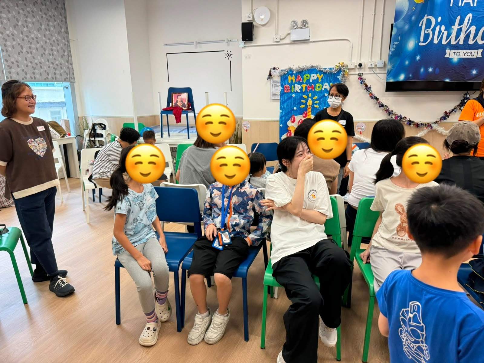 Participants sit in rows during an indoor activity.