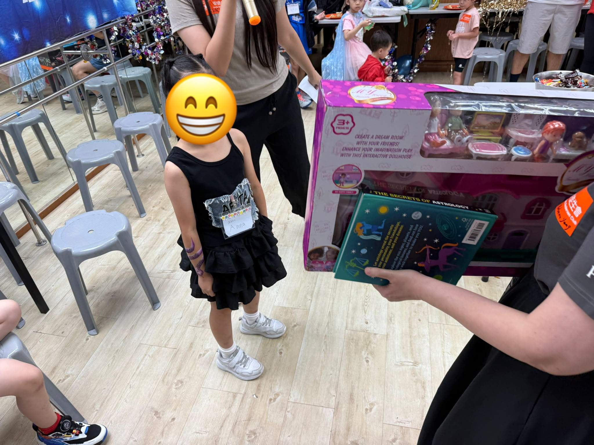 A child stands near several large boxed gifts.