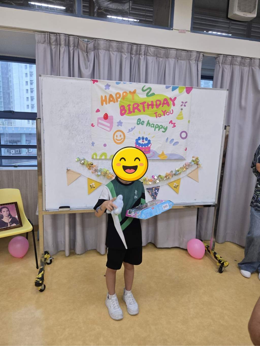 A participant displays a boxed gift and soft toy.