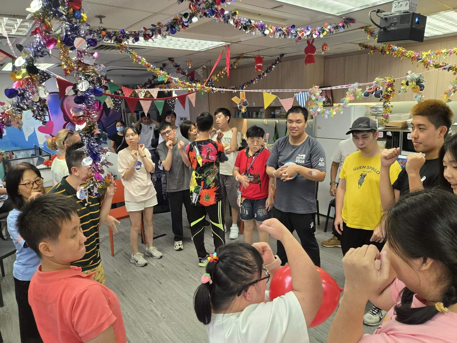 Participants join a circle game in the centre of the room.