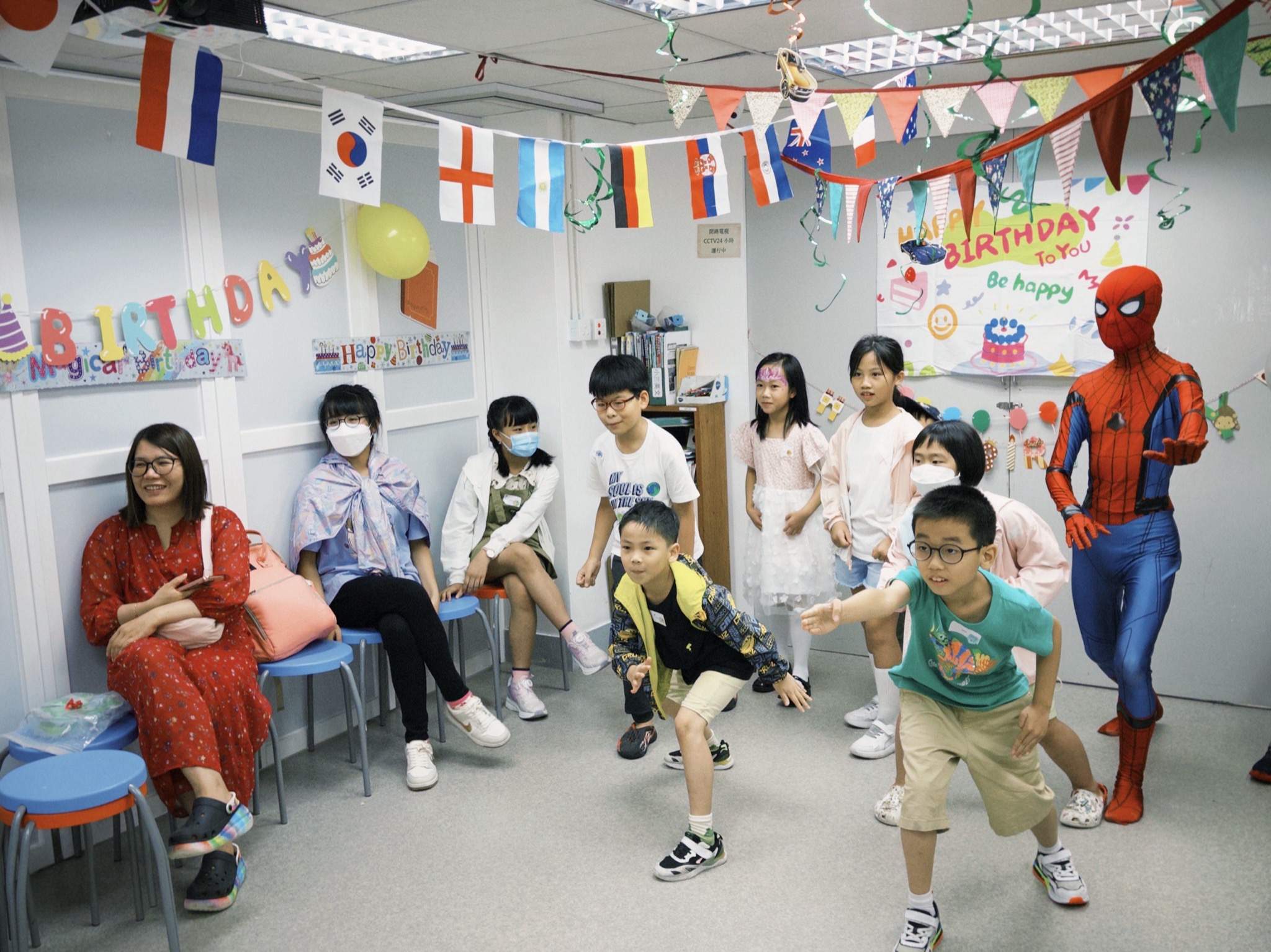 Children move through the room during a game with a performer.